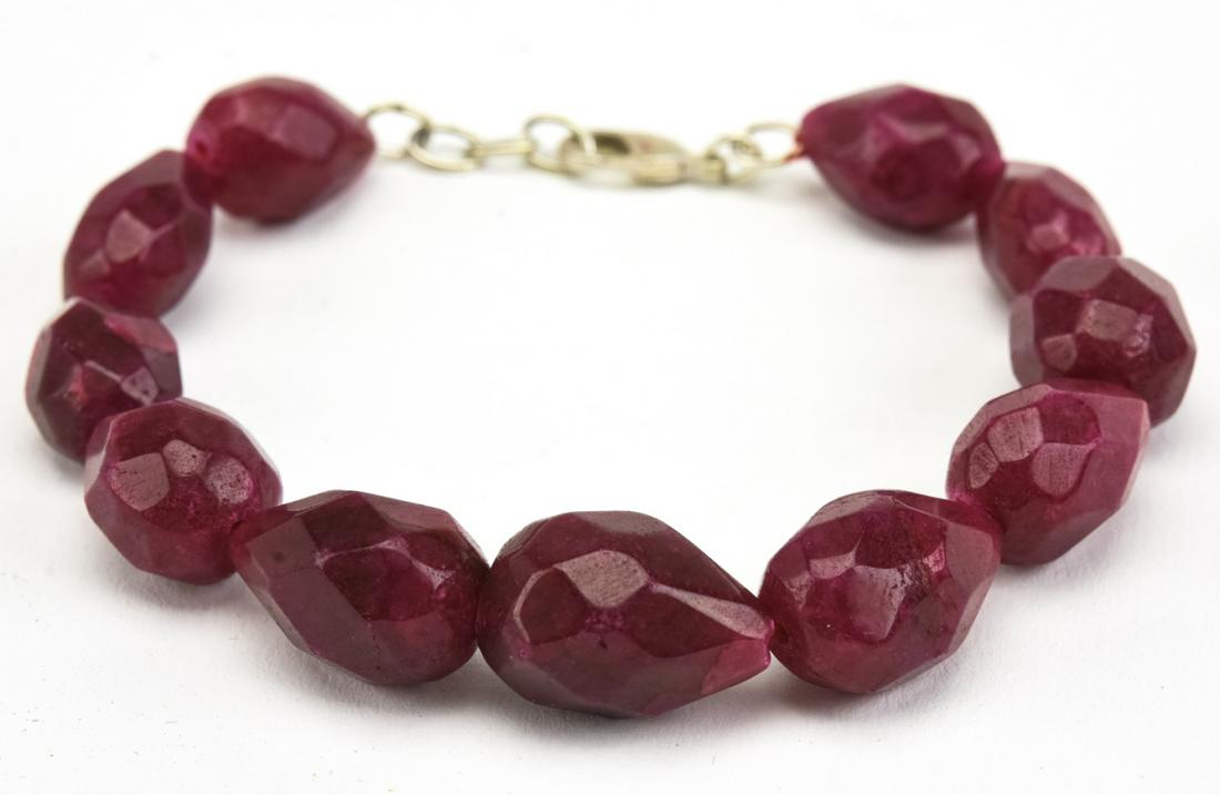 Bracelet w 200 Carats of Carved Ruby Beads: Bracelet w 200 Carats of Carved Ruby Beads. Faceted pear shaped ruby beads in varying tones of red.