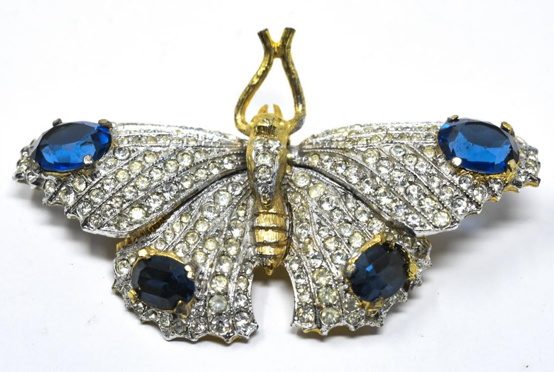 Kenneth J Lane Costume Butterfly En Tremblant Pin: Kenneth J Lane Costume Butterfly En Tremblant Pin . An older piece of KJL this butterfly pin/brooch is articulated so the wings move. Decorated with clear and sapphire-colored paste. Approx 2.5”