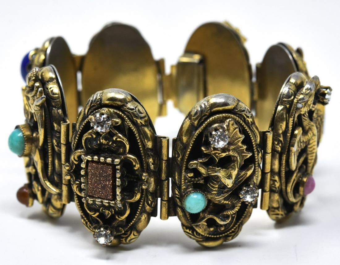 C 1950 Victorian Style Dragon Motif Panel Bracelet: Circa 1950 Victorian Style Dragon Motif Panel Bracelet. Panel bracelet with dragon and gargoyle motif, stone studded with multi colored cabochons. 7 inches in length.