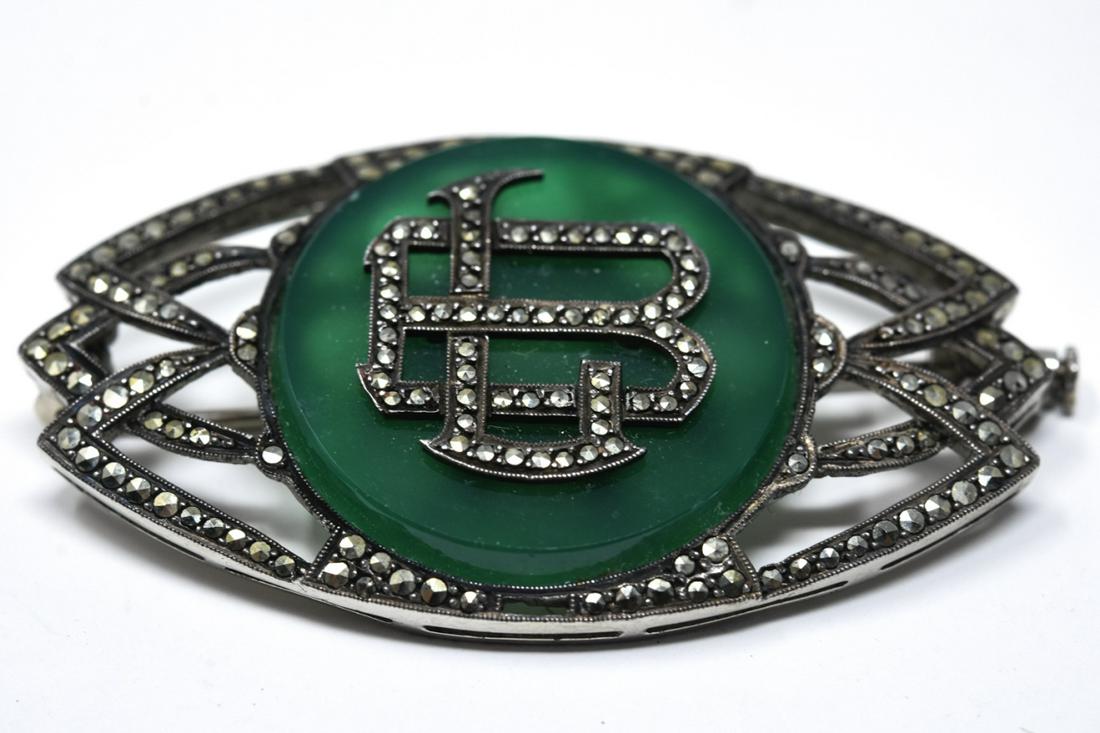 French Sterling Agate & Marcasite Deco Brooch: French Sterling Agate & Marcasite Deco Brooch. Deco brooch modeled in sterling silver with marcasite and green agate. Monogrammed initials at center. Measures 2 inches x 1 inch.