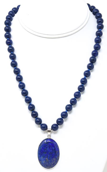 Carved Lapis Lazuli Necklace w Cabochon Pendant: Carved Lapis Lazuli Necklace w Cabochon Pendant. Hand knotted. Measures 17.5 inches in length.