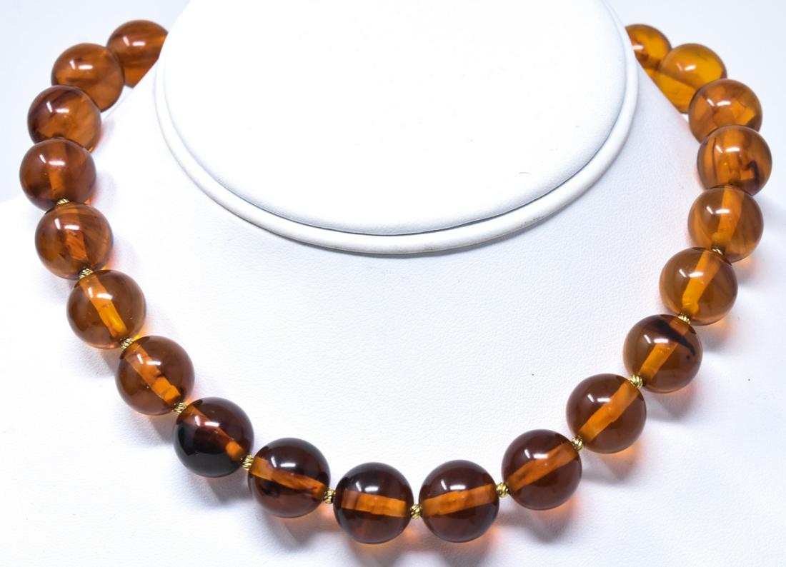 Vintage Trifari Faux Amber Acrylic Bead Necklace: Costume Jewelry Vintage Trifari Faux Amber Acrylic Bead Necklace Strand. Signed on clasp. Measures 15.75 inches in length.
