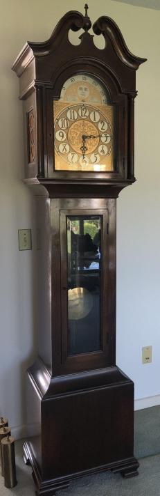 Chippendale Style Chiming Grandfather Clock: Chippendale Style Contemporary Chiming Grandfather Clock with Gold Tone Face and Sun Motif. 85 inches x 18 inches x 14 inches
