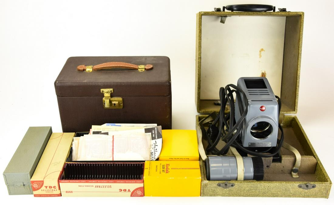 Vintage Kodaslide Slide Projector and Slide Cases: Vintage Kodaslide Slide Projector and Slide Cases. Projector is in original case and slide boxes are made of different materials and come in a leather handled vintage case. Slide projector case measur