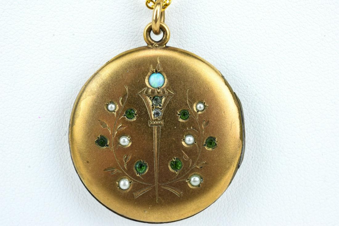 Antique 19th C Gold Locket w Torch & Wreath Motif: Antique 19th C Gold Locket w Torch Design Motif. Antique 19th century locket necklace pendant with torch and wreath design set with seed pearls and an opal. Chain measures 18 inches in length.