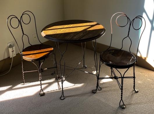 Antique Wrought Iron Cafe / Ice Cream Parlor Table: Antique Wrought Iron Cafe / Ice Cream Parlor Table w Two Chairs. Table measures 29 x 28 inches.