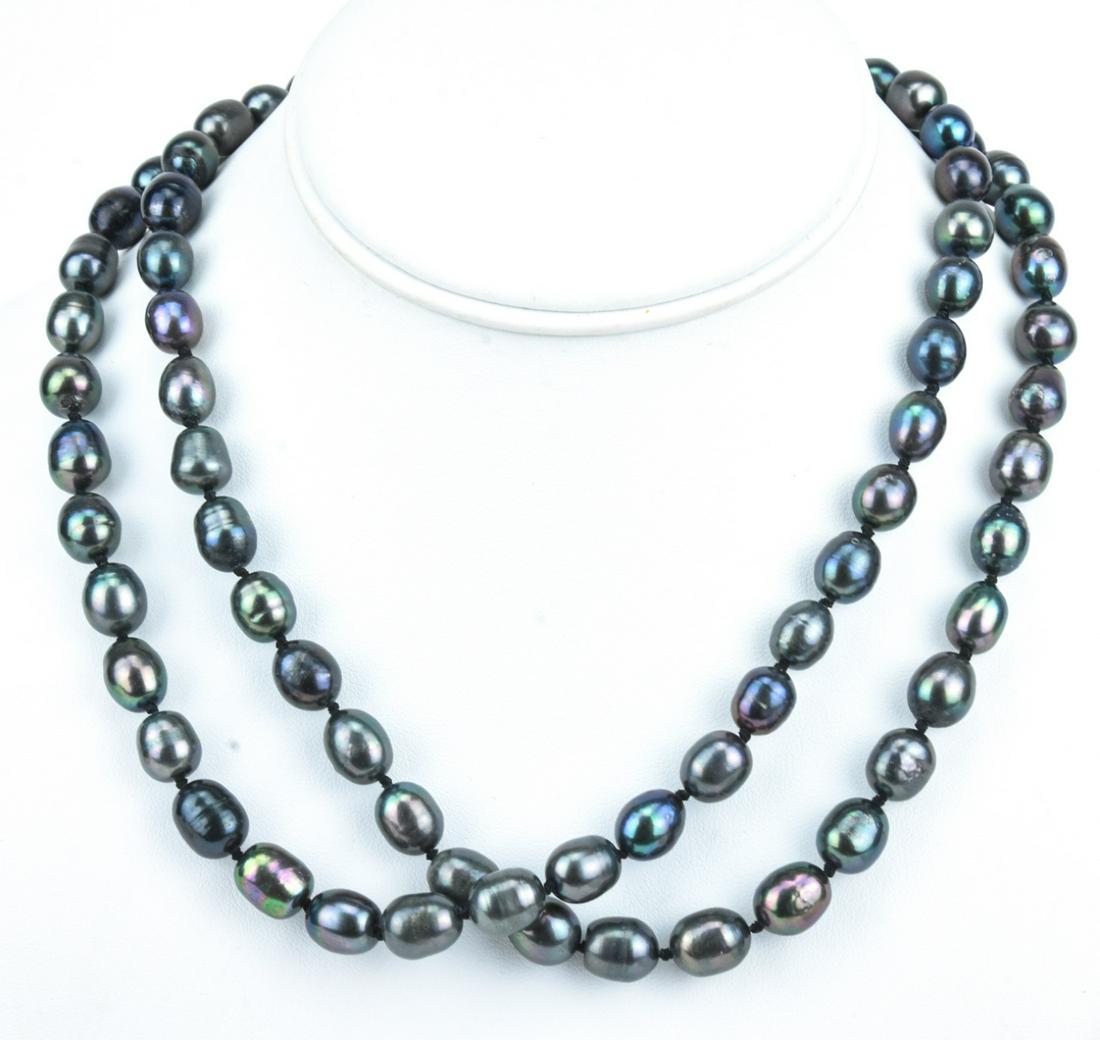 Pair Baroque Tahitian Pearl Hand Knotted Necklace: Pair Baroque Tahitian Pearl Hand Knotted Necklaces. Hand knotted on silk thread. Baroque pearls with tones of grey, silver and black. Filigree clasps. Each strand measures just over 18 inches in lengt