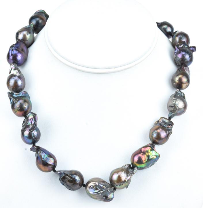 Large Cultured Baroque Tahitian Pearl Necklace: Large Cultured Baroque Tahitian Pearl Necklace. Hand knotted on silk thread. High luster iridescent tones of silver, black, grey and gold / champagne. Measures 18.5 inches in length. Pearls are approx