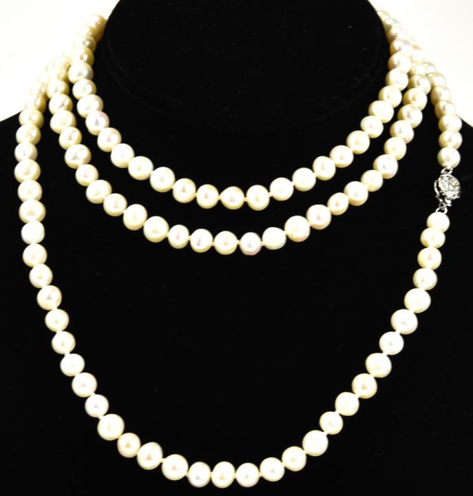 Hand Knotted Baroque Pearl Opera Length Necklace: Hand Knotted Baroque Pearl Opera Length Necklace. Hand knotted on silk thread. Rose motif clasp. Measures 48 inches in length.