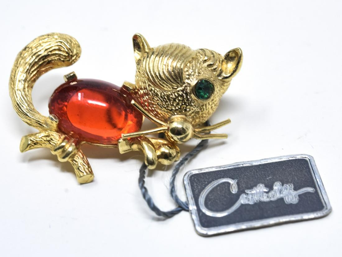 Castlecliff Gilt Cat Motif Pin / Brooch: Castlecliff Gilt Cat Motif Pin / Brooch. With red oval cabochon torso and green paste eye. With original hang tag. Measures 1.25 inches in width.
