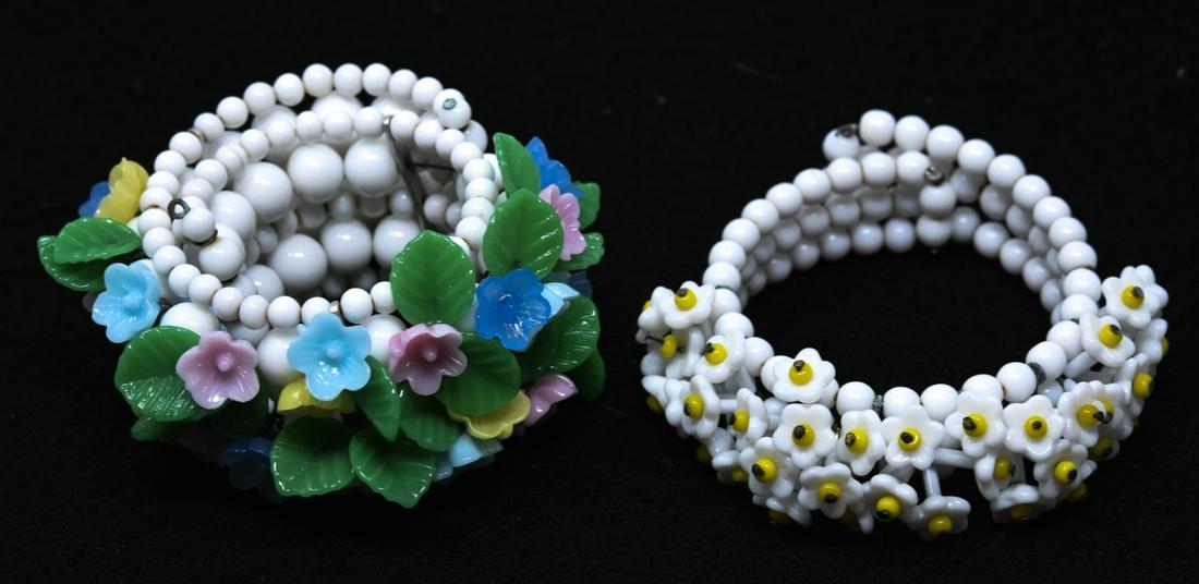 2 C 1950 White Glass Floral Design Bracelets: 2 C 1950 White Glass Floral Design Bracelets. Each with white glass bead coil design with hand blown glass 3D flowers. Widest measures 1 1/8 inches. Expandable.