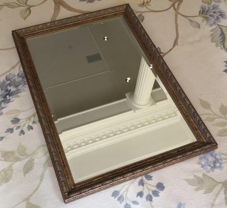 Antiqued Carved Gilt Mirror: Antiqued Carved Gilt Mirror. Measures 40.5 inches x 28.5 inches
