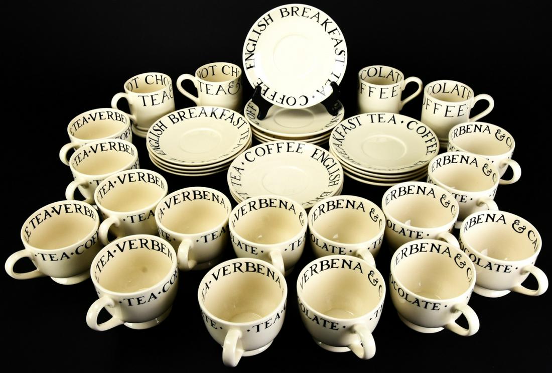 Set Emma Bridgewater Mugs, Cups, & Saucers: Set Emma Bridgewater Mugs, Cups, & Saucers. Includes 16 saucers, 15 teacups, and 4 mugs. Saucers read "English Breakfast Tea, Coffee". Teacups read "Tea, Coffee, & Hot Chocolate" on outside and "Verbe