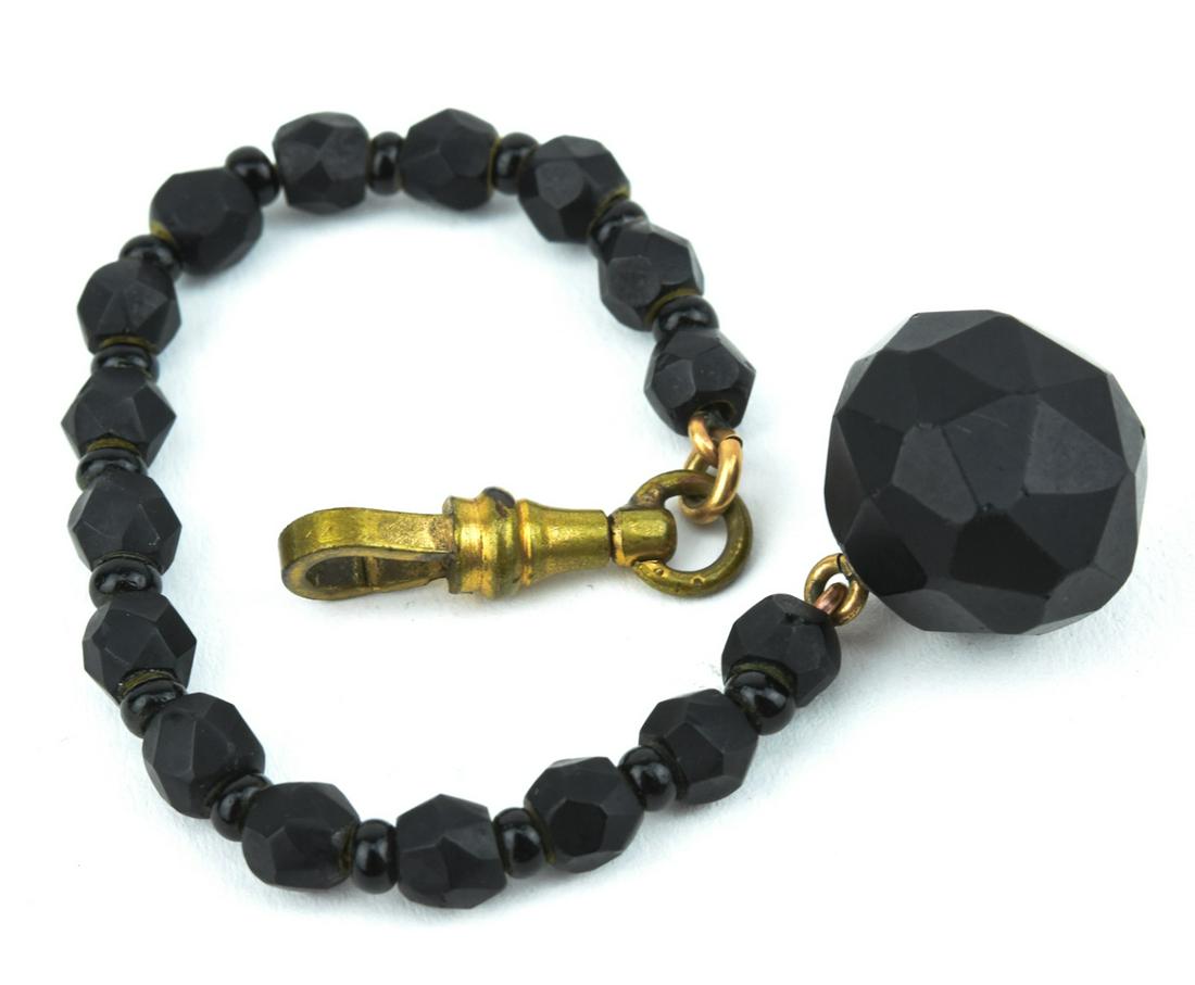 Antique 19th C Whitby Jet Watch Fob Pendant: Antique 19th C Whitby Jet Watch Fob. Dog clip, hand cut Whitby jet, and black glass spacers. Measures 6 inches in length.