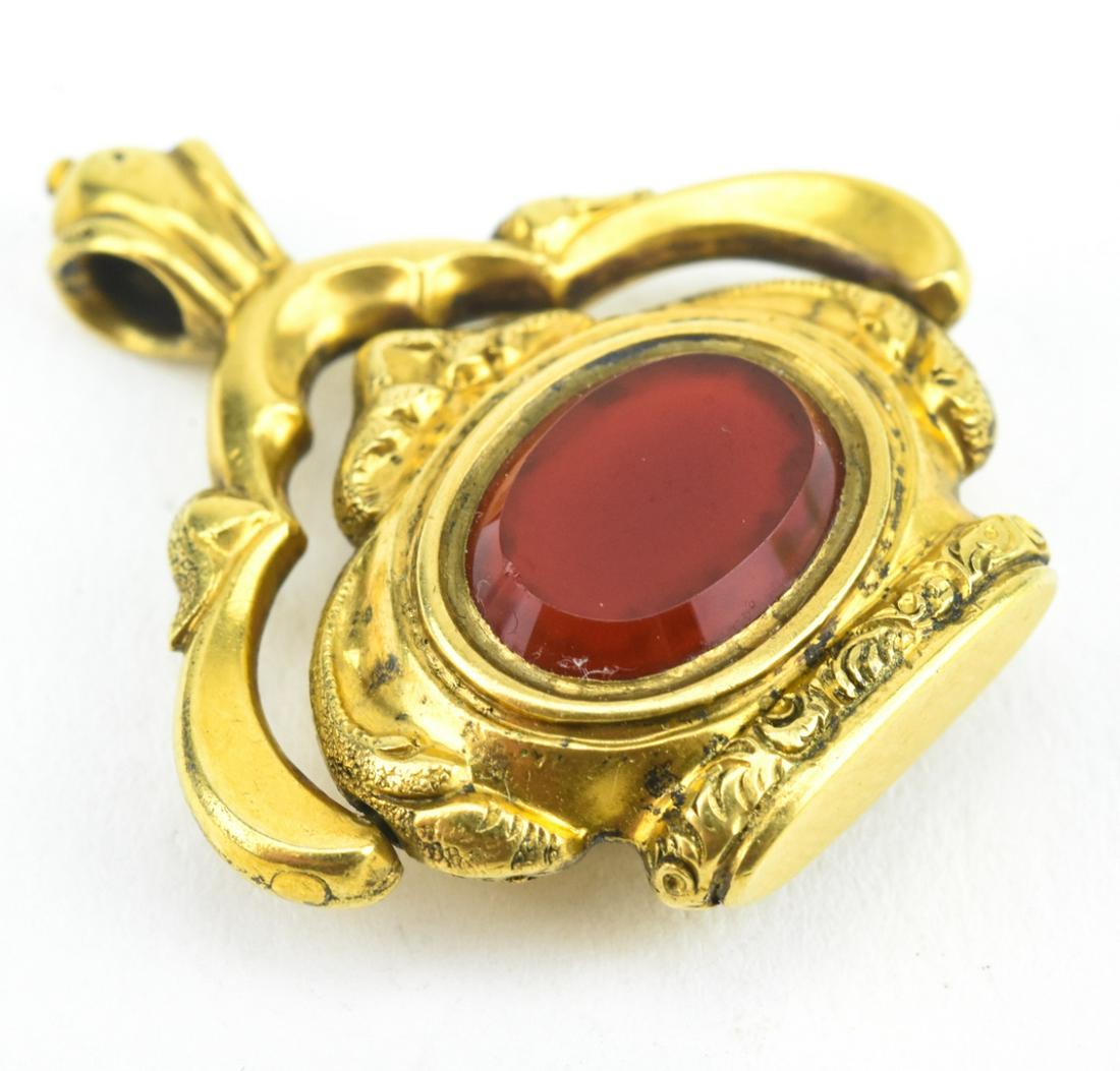 Antique 19th C Gold Spinner Fob Pendant: Antique 19th C Gold Spinner Fob/Necklace Pendant. Set on one side with Carnelian and one side with bloodstone. Acid tests for 10 KT, may be gold filled. Measures 1.25 inches in length