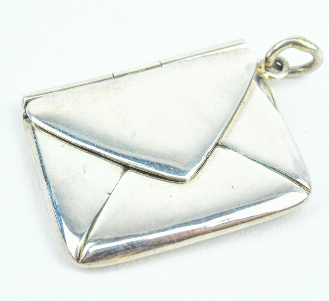 Estate English Sterling Envelope Form Locket: Estate English Sterling Envelope Form Locket. Necklace pendant i the form of an envelope, opens to hold a picture or note. Back with full English hallmarks. Measures just over 1.5 inches in length.