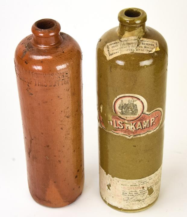 2 Antique Dutch Hulstkamp Stoneware Bottles: 2 Antique Dutch Hulstkamp Stoneware Bottles. Larger measures 11 inches x 3.25 inches.