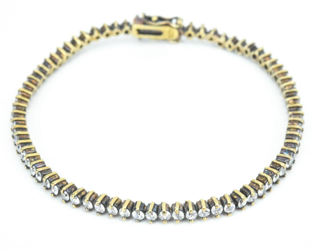 Vermeil Sterling Silver Tennis Bracelet: Vermeil Sterling Silver Tennis Bracelet. With synthetic diamonds. Measures 7.25 inches in length.