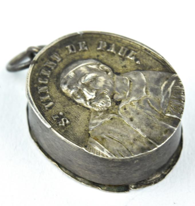 Antique St. Vincent De Paul Reliquary Locket: Antique St. Vincent De Paul Reliquary Locket Necklace Pendant. French silver with faint hallmarks. Case opens to a small relic. Measures 1 inches.