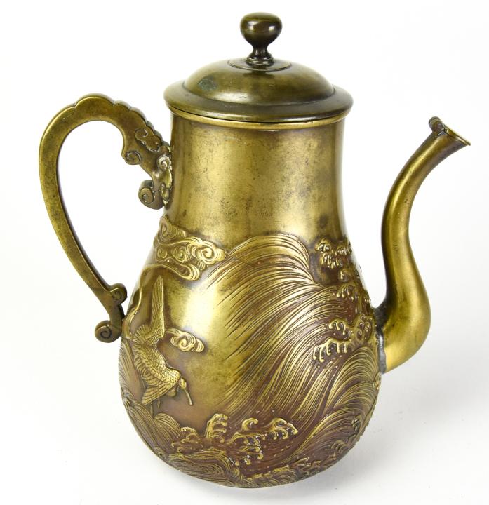 Asian Bronze Tea Pot Embossed Nature Scene: Asian Bronze Tea Pot Embossed Natures Scene of Ocean Waves, Mountains and Animals. Measures 9 inches in height by 7.5 inches in width by 4.25 inches in depth.