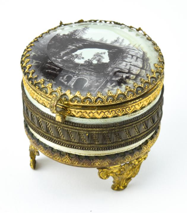 Antique 19th C Ormolu Jewelry Box: Antique 19th C Ormolu Jewelry Box. Beveled glass lid with photo. Measures 2 inches in diameter.