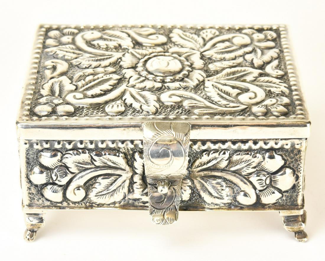 Large 900 Silver Repousse Jewelry Box: Large 900 Silver Repousse Jewelry Box. Repousse and chased design of flowers and leaves. Weighs approximately 320 grams. Measures 5 by 4.5 inches.