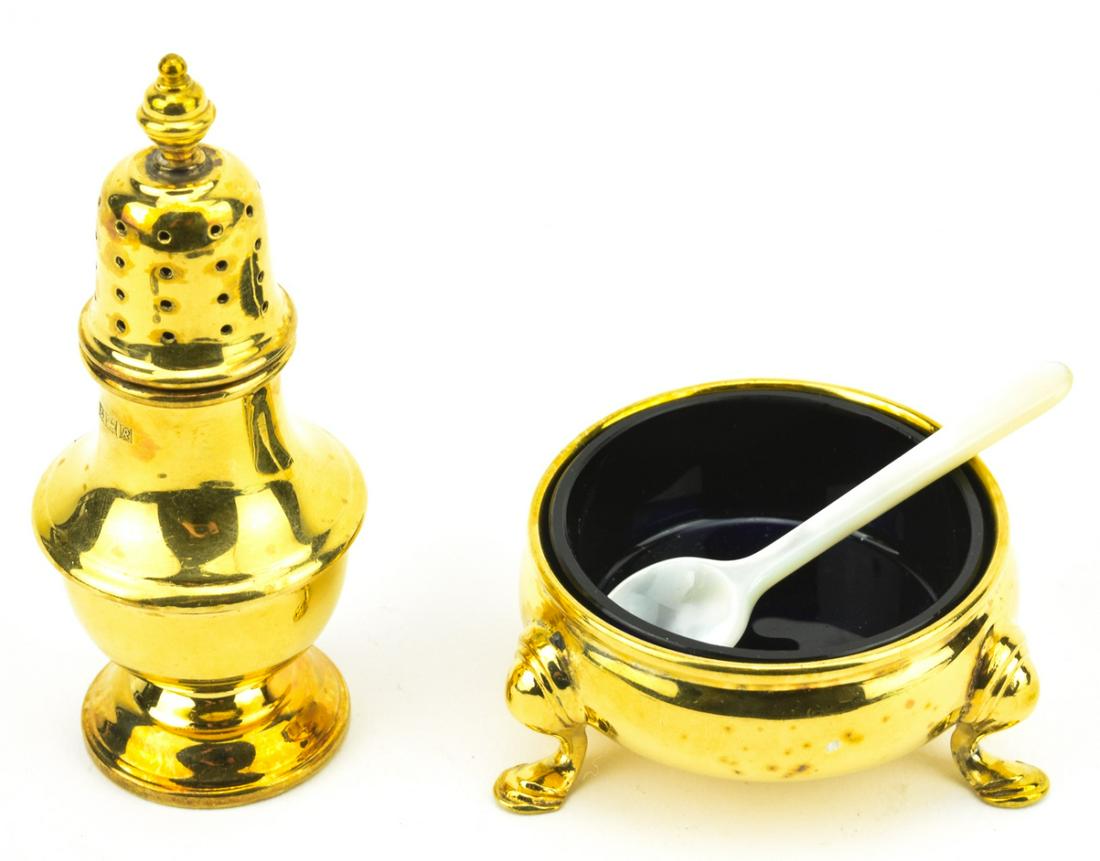 Tiffany & Co Gold Over Sterling Salt & Pepper Set: Tiffany & Co Gold Over Sterling Salt & Pepper Set. Gold plated over sterling silver salt cellar and pepper shaker with carved mother of pearl spoon. Pepper shaker measures just over 3 inches in height