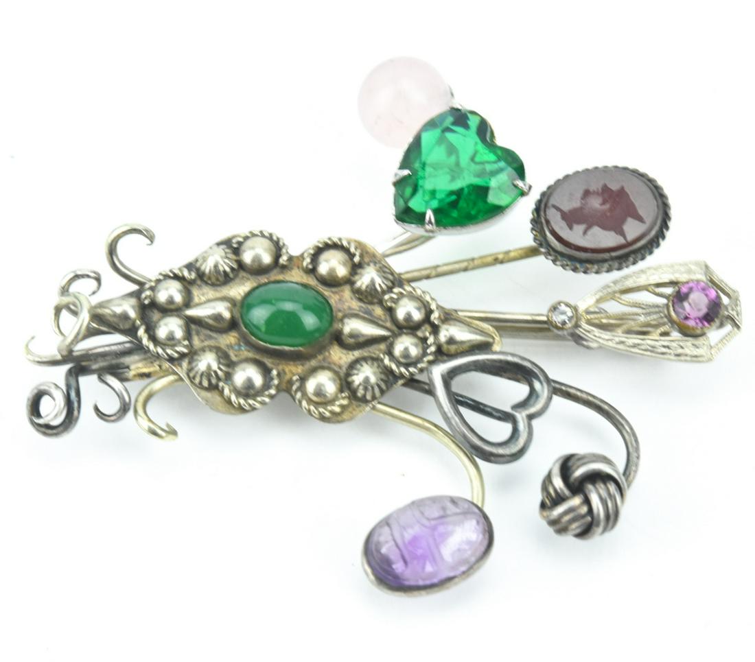 Handmade Brooch using Antique Stick Pins: Handmade Brooch using Antique Stick Pins. Sterling silver with rose quartz, amethyst, scarab, emerald paste heart, carnelian intaglio, Edwardian shield, sterling knot and sterling heart. Measures 2.5