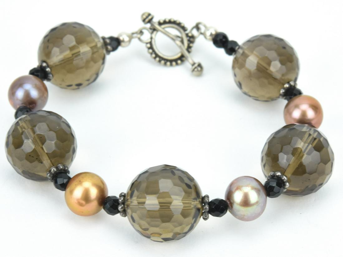 Sterling Smoky Quartz & Onyx Bracelet: Sterling Smoky Quartz & Onyx Bracelet. Handmade bracelet with faceted smoky quartz and onyx beads. Measures 8 inches in length.