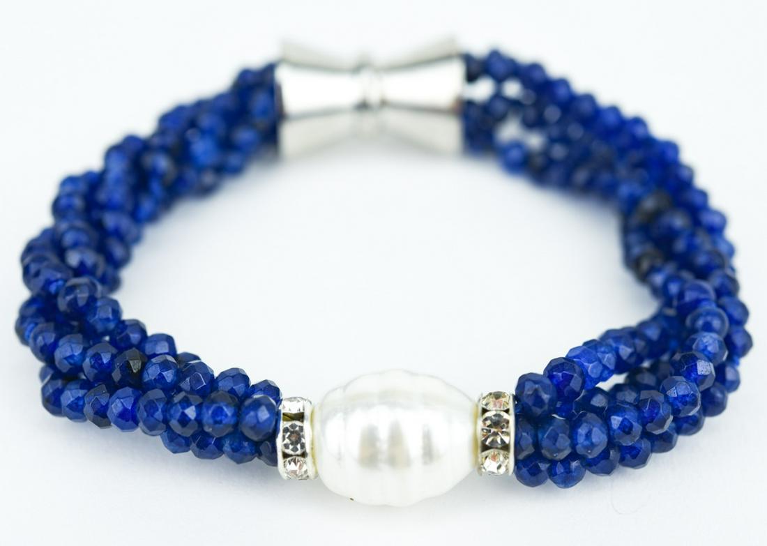 Multi Strand Sapphire & Baroque Pearl Bracelet: Multi Strand Sapphire & Baroque Pearl Bracelet. Four (4) strands of faceted blue sapphires with baroque pearl at center. Measures 8 inches in length. Sapphire beads may be treated or enhanced.