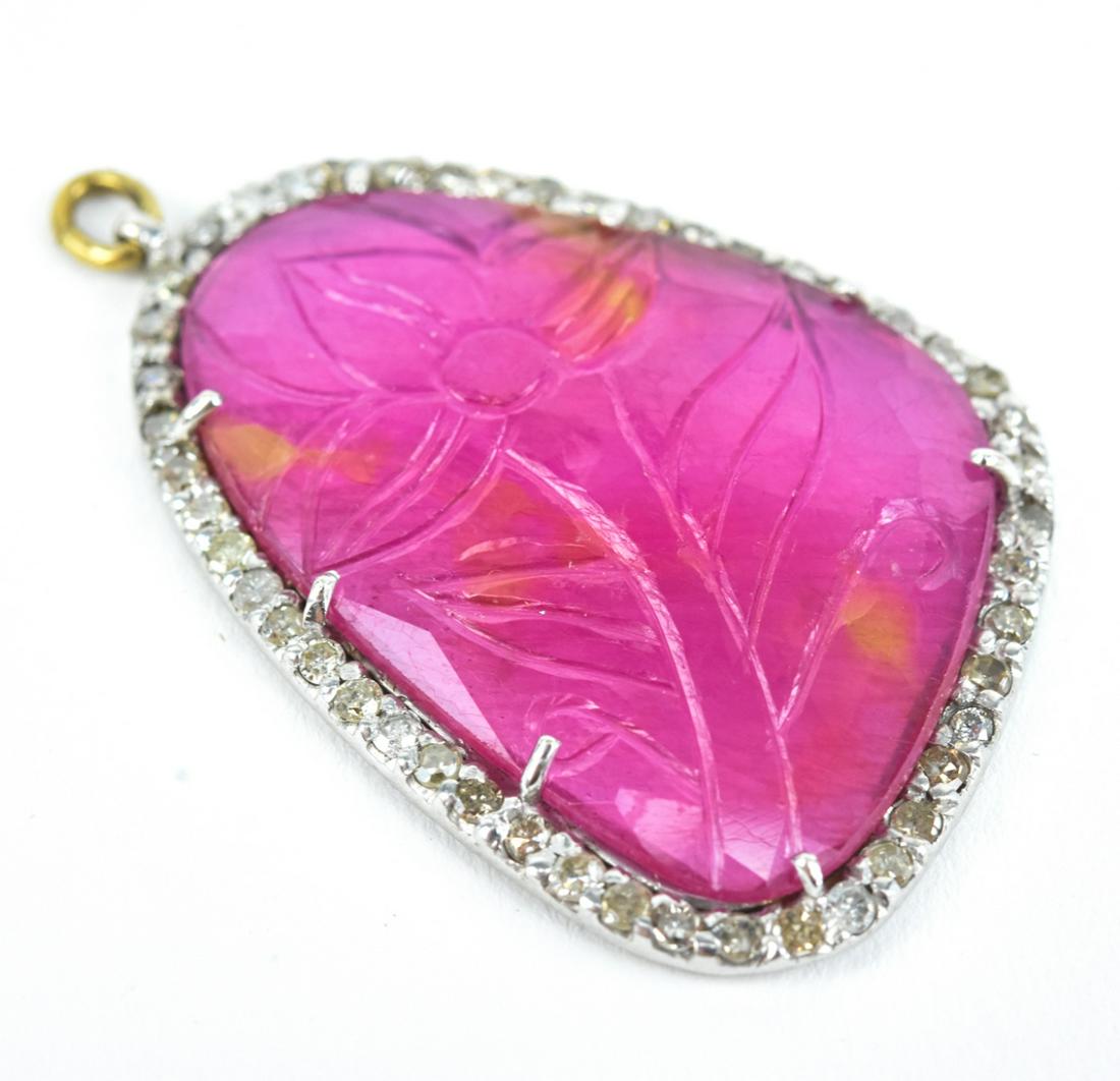 Hand Carved Ruby Panel w Diamond Halo Pendant: Hand Carved Ruby Panel w Diamond Halo Necklace Pendant w Sterling Silver Setting. Measures 1.75 inches in length. Approximately .50 of a carat of diamonds.