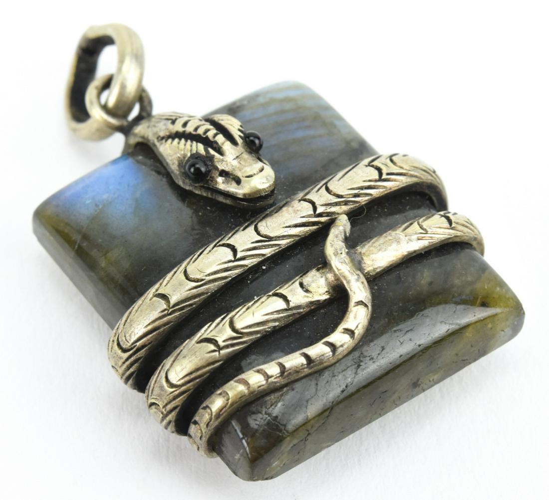 Handmade Labradorite & Sterling Snake Pendant: Handmade Labradorite & Sterling Snake Pendant. Handmade silver snake with cabochon eyes coiled around a carved panel of labradorite. Measures 1.75 inches in length.