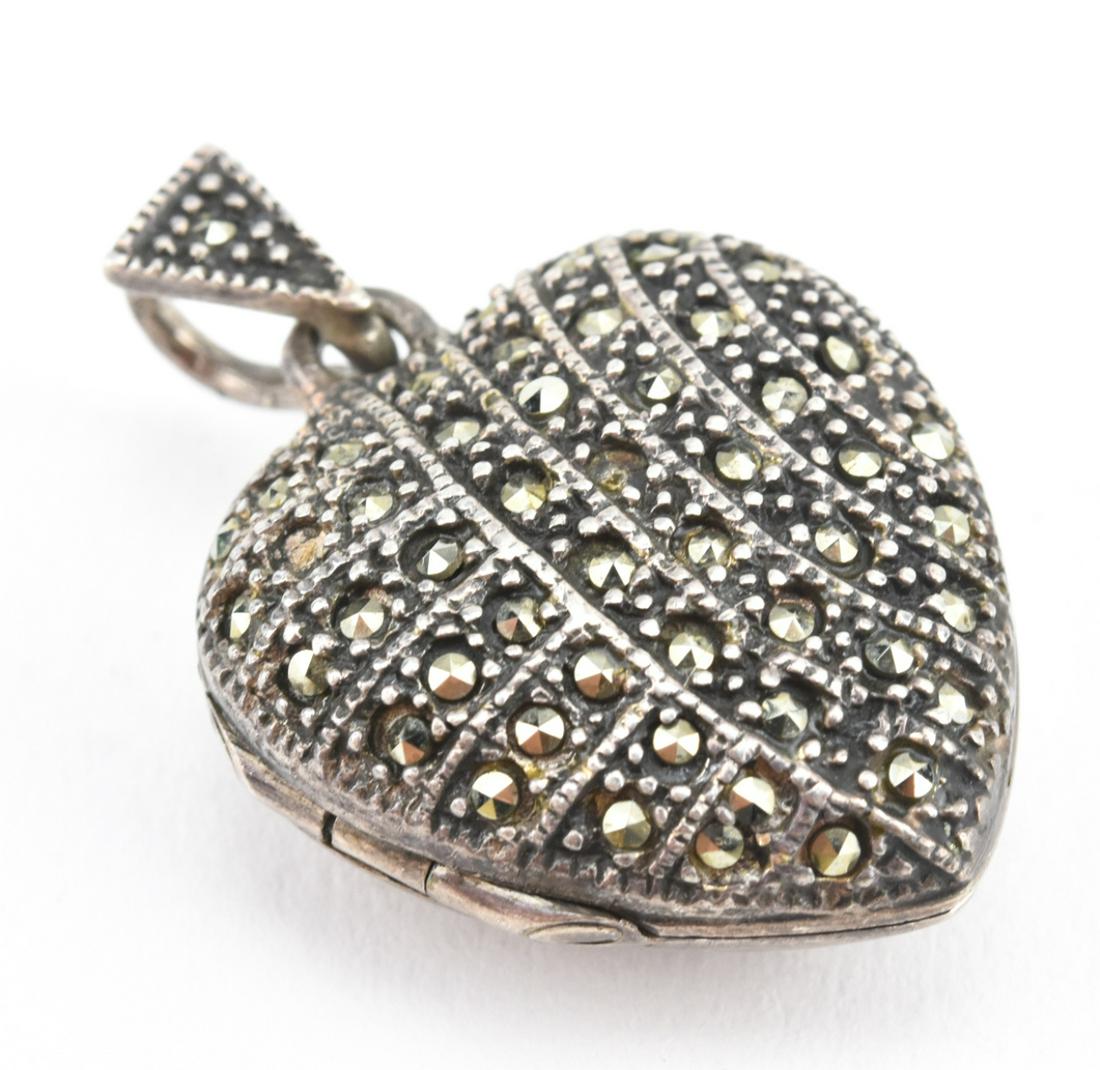 Art Deco Style Sterling & Marcasite Locket: Art Deco Style Sterling & Marcasite Locket. Heart form locket necklace pendant with rose-cut pave set marcasite stones. Measures 1.25 inches in length.