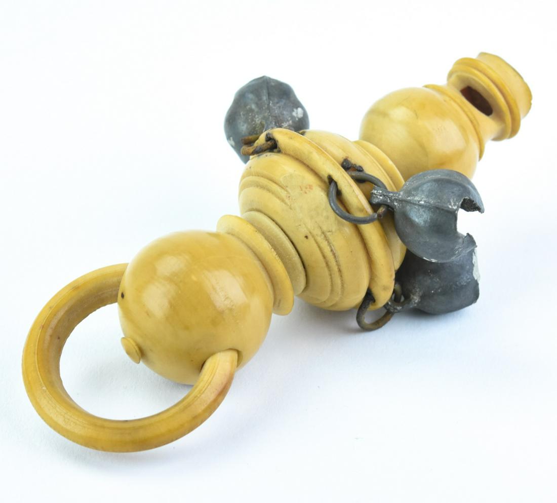 Antique 19th C Carved Bone Whistle/Rattle: Antique 19th C Carved Bone Whistle/Rattle. Antique baby's toy, carved bone whistle with four attached bells and teething ring at end. Measures 3.75 inches in length.