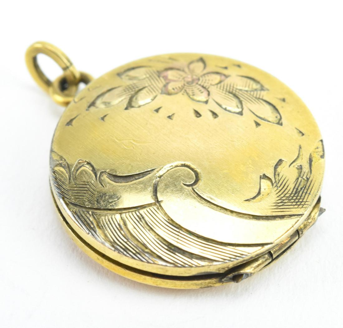 Antique Gold Floral & Scrollwork Locket: Antique Gold Floral & Scrollwork Locket. Gold filled locket with engraved front panel. Measures just over 1 inch in length.