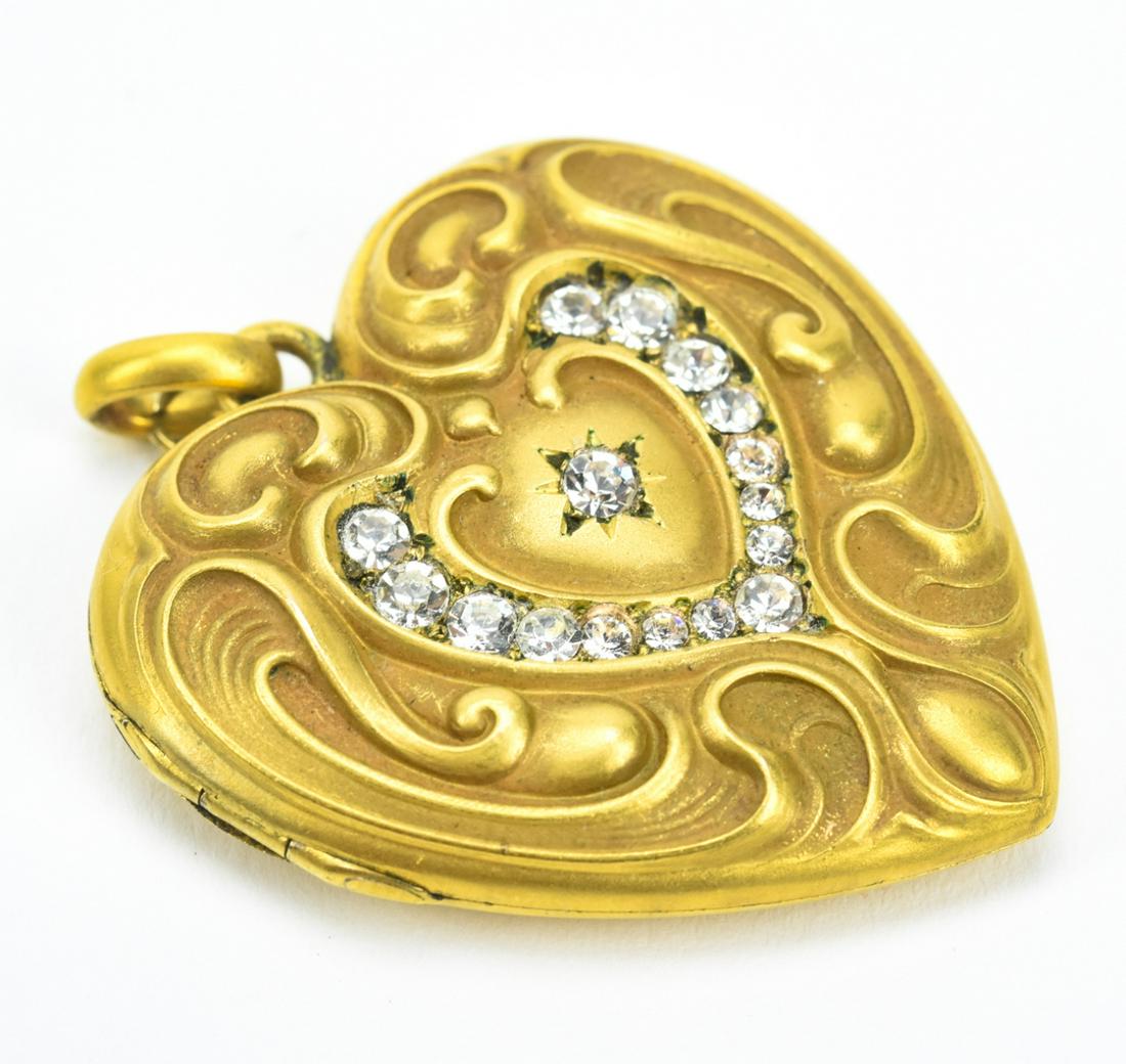 Antique C 1910 Art Nouveau Gold Locket: Antique C 1910 Art Nouveau Gold Locket. Yellow gold filled heart shaped locket necklace pendant set with clear paste stones. Measures 1.75 inches in length.