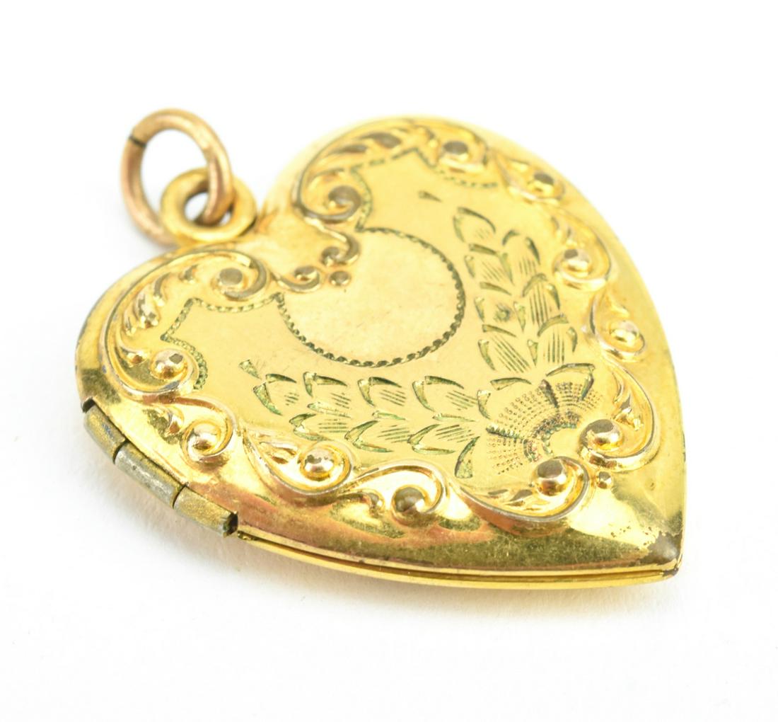 Antique Gold Scrollwork Heart Form Locket: Antique Gold Scrollwork Heart Form Locket. Gold filled, heart form locket with scrollwork order. Measures 1.25 inches in length.