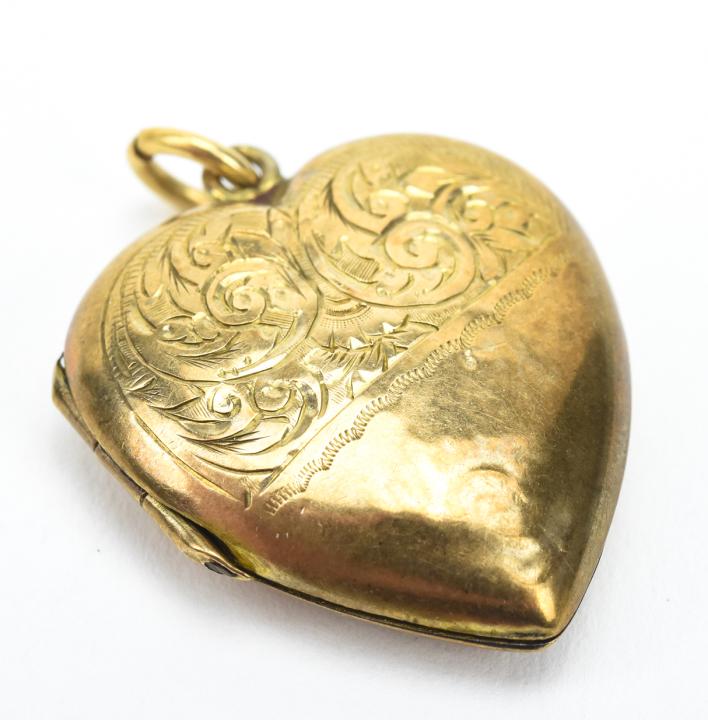 Antique English 9kt Gold Heart Locket: Antique English 9kt Gold Heart Locket. 9kt yellow gold, heart form locket necklace pendant. Measures 1.25 inches in length.