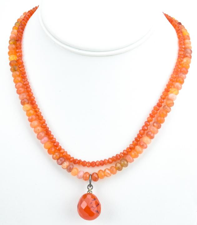 Double Strand Sterling Silver & Carnelian Necklace: Double Strand Sterling Silver & Carnelian Necklace. Hand faceted rondelle carnelian beads with briolette carnelian necklace pendant. Sterling silver clasp. Measures 18 inches in length.