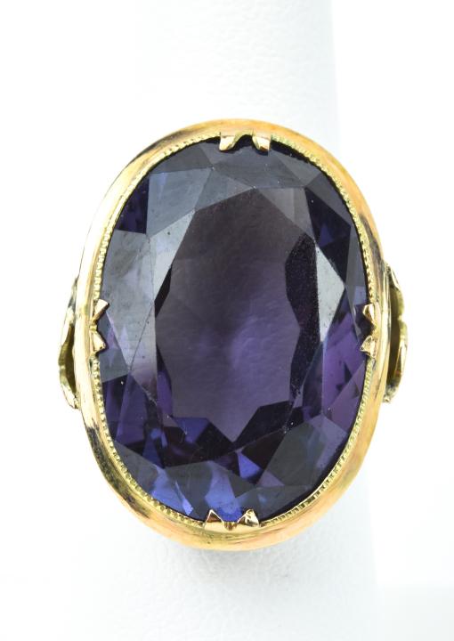 Estate 18kt Yellow Gold & Large Alexandrite Ring: Estate 18kt Yellow Gold & Large Alexandrite Ring. 18kt yellow gold setting holding a large oval cut synthetic alexandrite stone that measures just under 1 inch in length. Ring can be resized. Weighs a