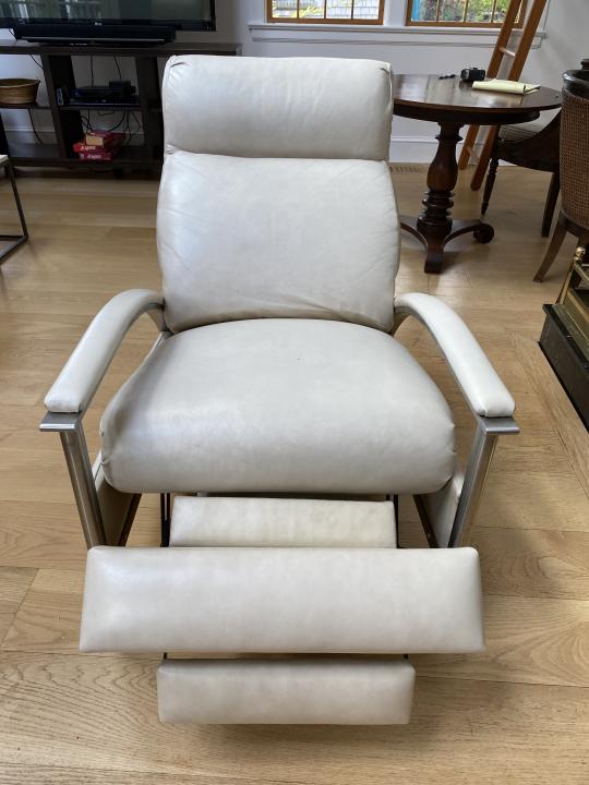 Modern Cream Leather Reclining Lounge Chair: Modern Cream Leather Reclining Lounge Chair. With chrome base. Measures 41 inches high by 27.75 inches wide by 37 inches deep, 17 inches high from seat to floor.