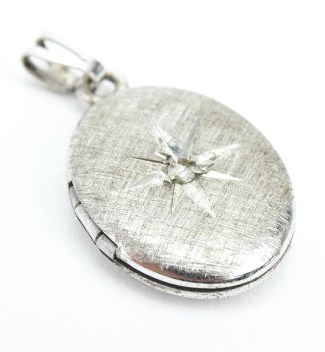 Estate Sterling Silver & Diamond Locket Pendant: Estate Sterling Silver & Diamond Locket Pendant. Gypsy set rose cut diamond and starburst. Measures just under 1 inch in length.