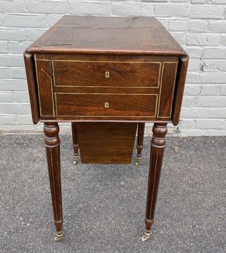 Sheraton Style Drop Leaf Banded Inlay End Table: Sheraton Style Drop Leaf Banded Inlay End Table. Features 3 drawers, Sits on carved, tapered legs with brass castors. Measures 27.5 inches high x 16 inches wide x 20 inches deep. Open table measures 2