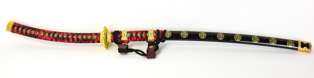 Shinshinto Japanese Samurai Sword Katana: Shinshinto Japanese Samurai Sword Katana. Includes Black Lacquered Wood Scabbard. Blade made of stainless steel. Gilded guard, edge of sword and scabbard. Red & Black silk wrapped tsuka. Measures 43 i
