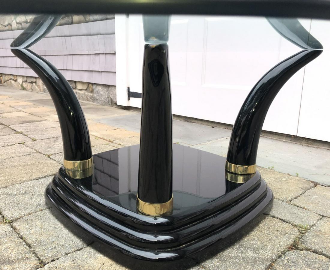 Mid C Henredon Black Lacquer Tusk Base Table: Mid C Henredon Black Lacquer Tusk Form Base Coffee Table. Carries makers mark. Brass accents on black lacquer with glass top. 17 inches x 44 inches x 14 inches This sale is online only - no public pre