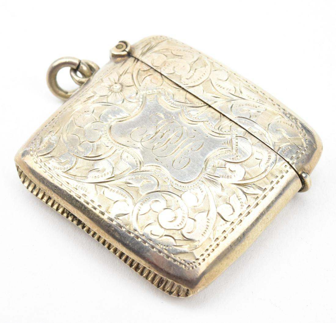 Antique 19th C English Sterling Vesta Pendant: Antique 19th C English Sterling Vesta Pendant. Sterling silver match safe pendant with chased floral and scrollwork design having a shield at center. Full English hallmarks. Measures just over 2 inche
