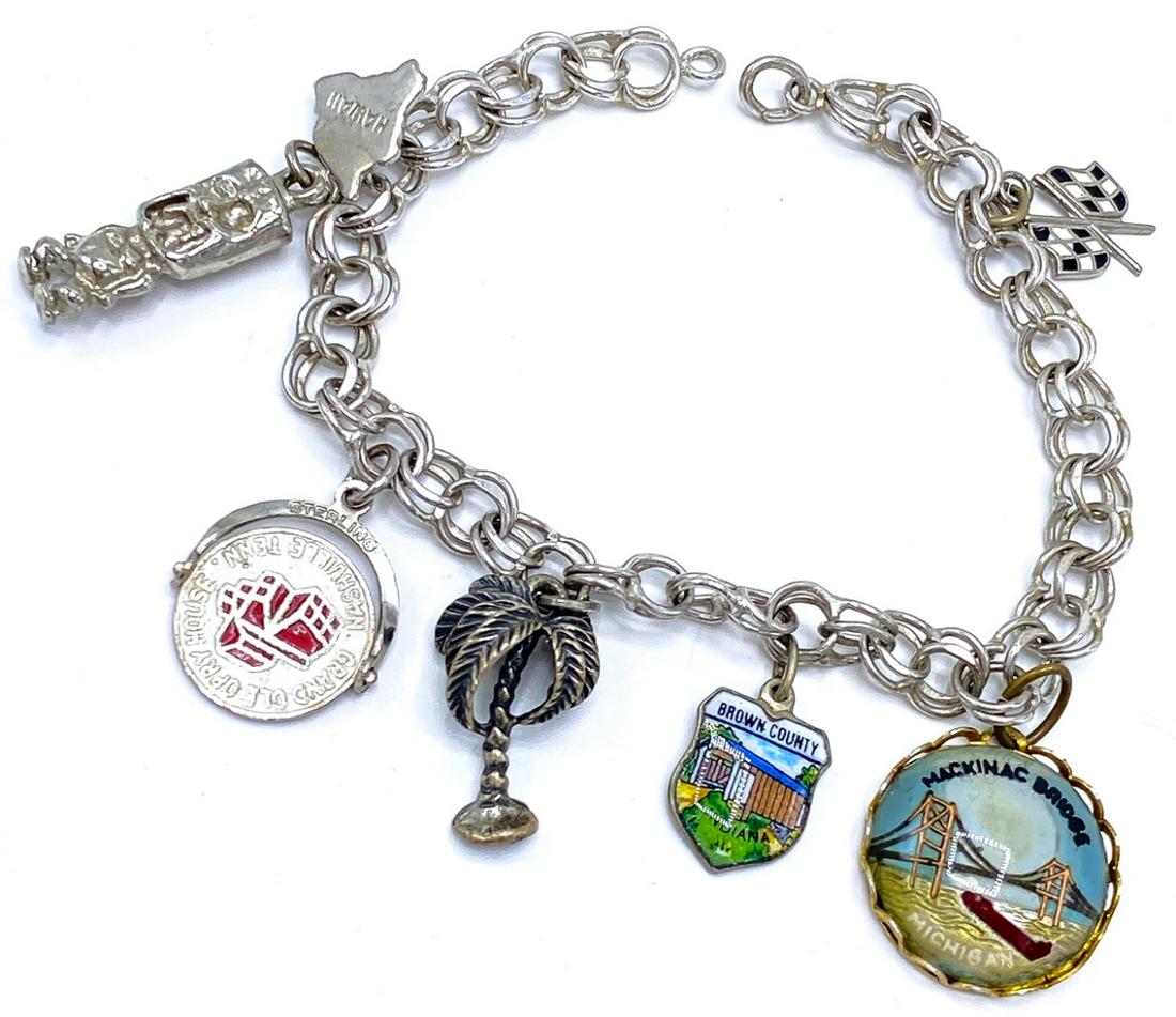 Vintage Sterling Silver Charm Bracelet: Vintage Sterling Silver Charm Bracelet – A great vintage piece featuring mostly sterling charms including a totem from Hawaii, a Grand Ole Opry House spinner charm, a palm tree, a Indiana enamel shi