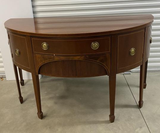 Baker Federal Style Demilune Mahogany Sideboard: Baker Federal Style Demilune Mahogany Sideboard. Features 4 cabinets and 1 drawer with banded inlay and brass hardware. Sits on tapered legs with arrow feet. Measues 37.25 inches high x 66 inches wide