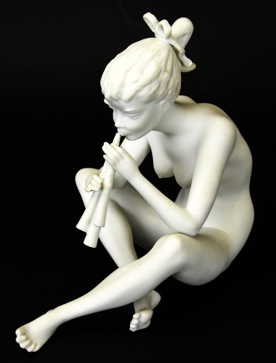 Kaiser Porcelain Nude Girl Playing Flute Sculpture: Kaiser Porcelain Nude Girl Playing Flute Sculpture. Measures 7.5 inches high by 4.5 inches wide by 7 inches deep.