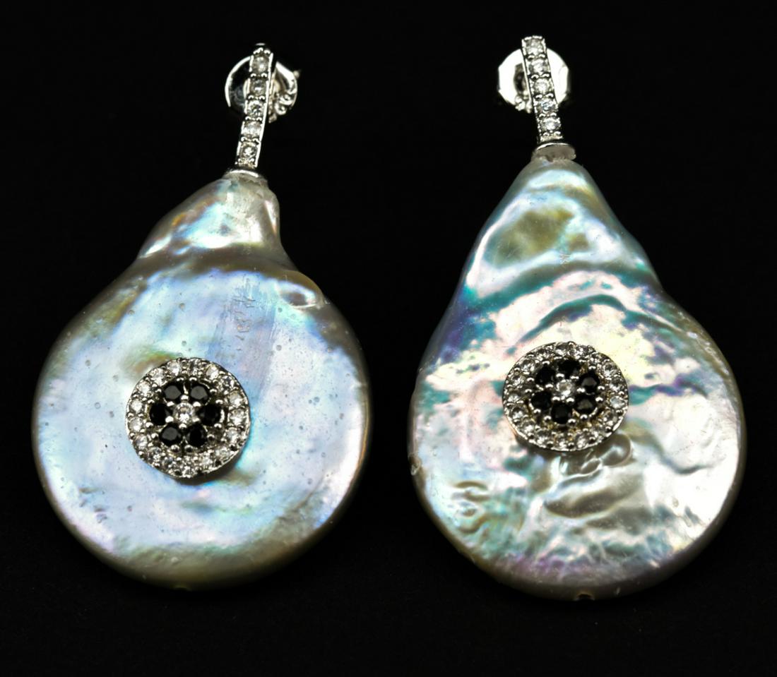 Pair Baroque Coin Pearl Ruby Set Earrings: Pair Of Baroque Coin Pearl Ruby Set Earrings. Pair of baroque coin-shaped, high-luster, pink iridescent pearls mounted with floral motif at center. Stones test as ruby on the Presidium, may be treated